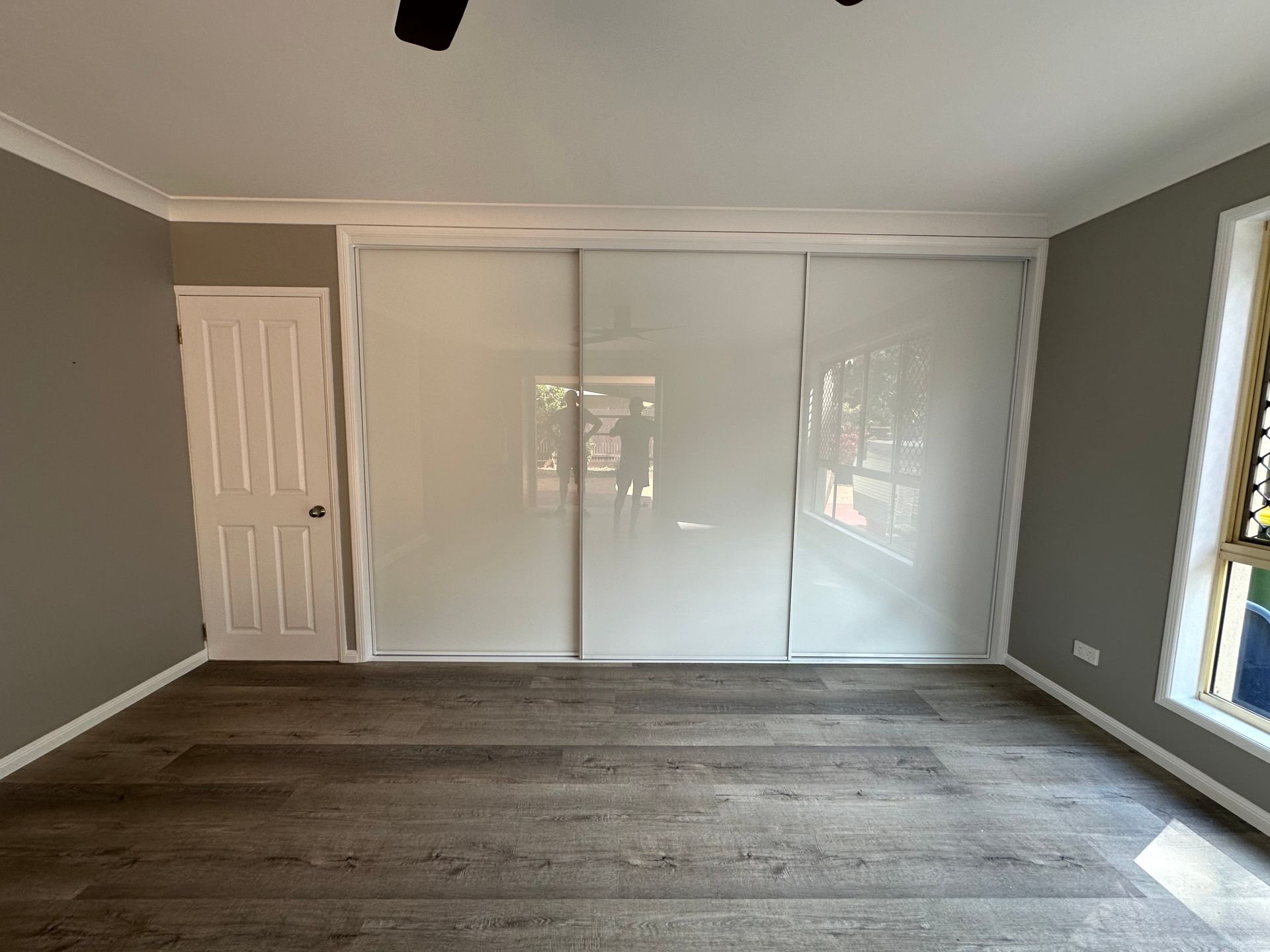 A house with a sliding glass door leading to a living room.