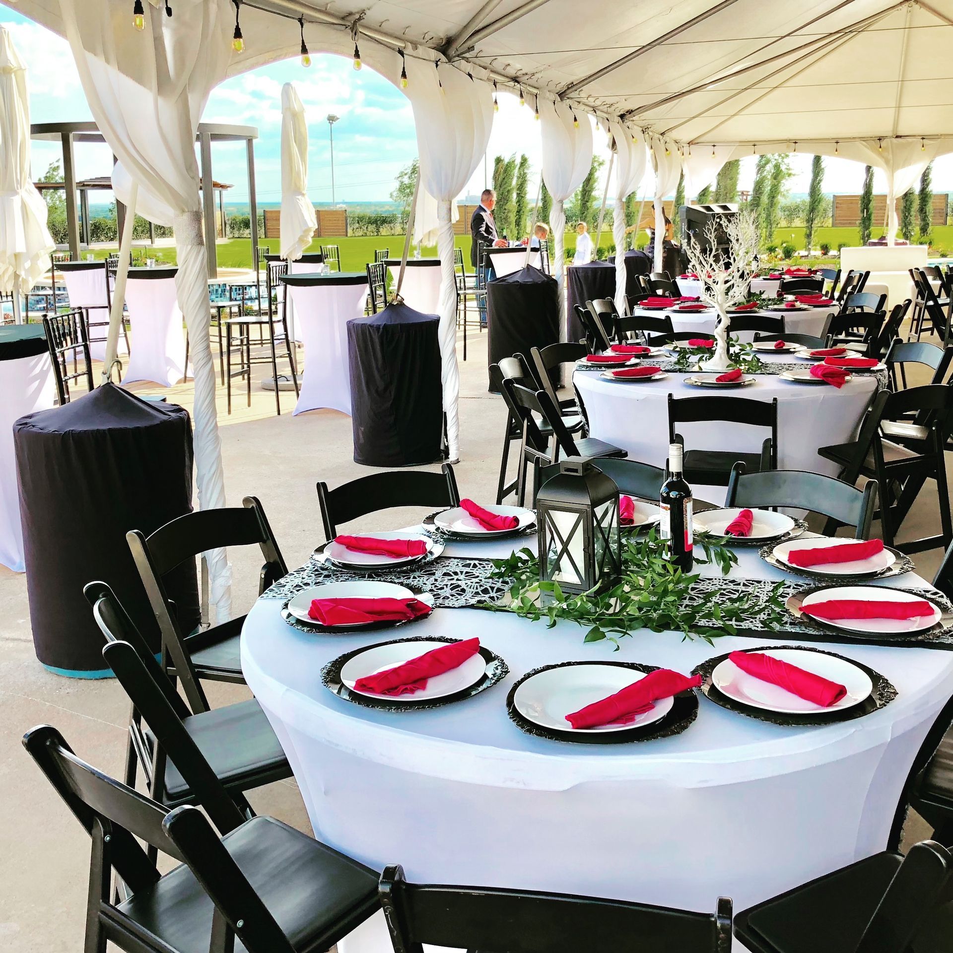 A Tent With Tables and Chairs Set Up for a Party