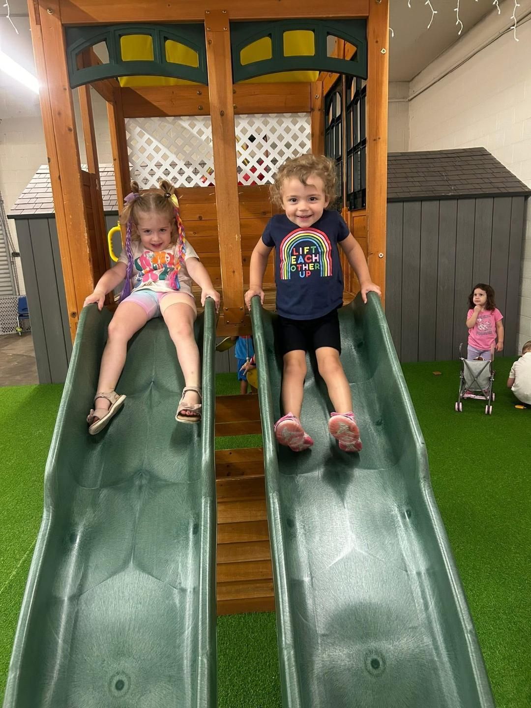 Child holding groundhog art with a heart; in a classroom.
