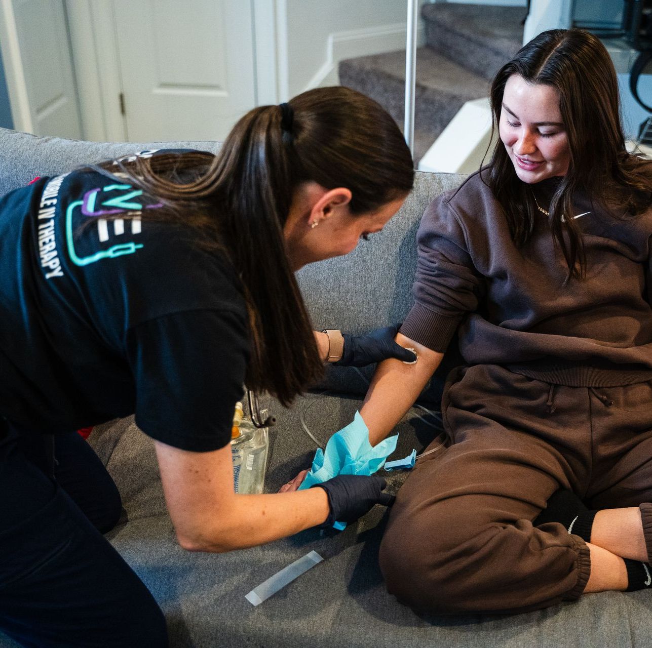 Revive employee preparing the medicine for   the  woman  beside her