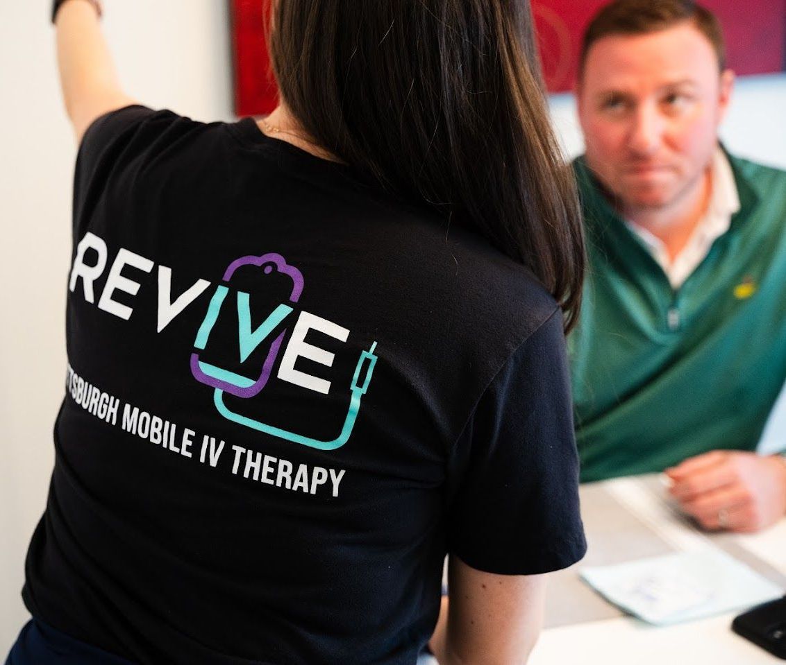 A woman wearing a black shirt with the word revive on it