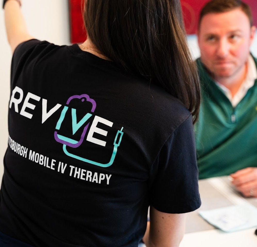 A woman wearing a black shirt that says revive on it