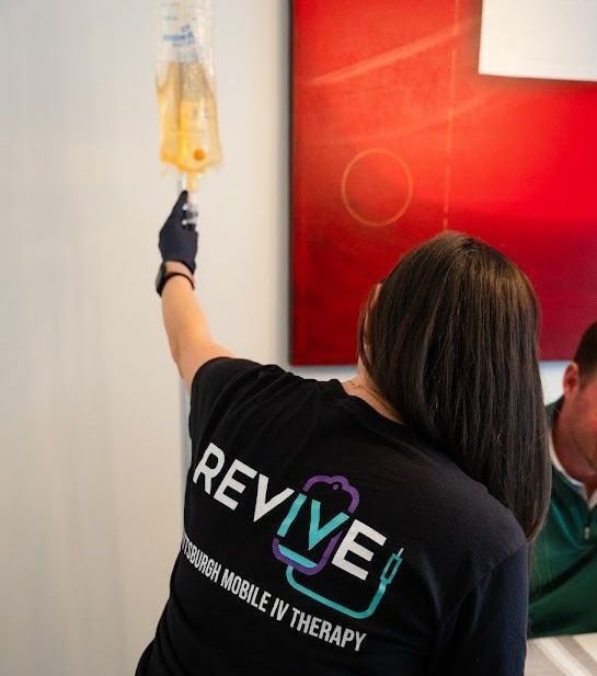 A woman wearing a black shirt that says revive