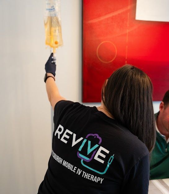 A woman wearing a black shirt with the word revive on it