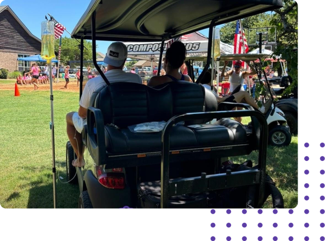 A group of people are sitting in a golf cart.