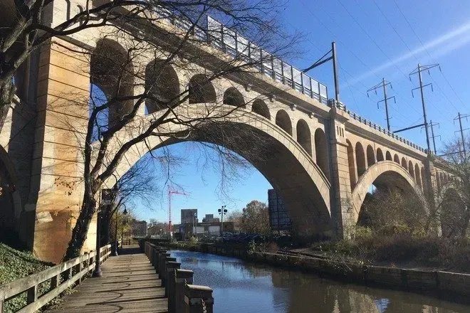 A city skyline with a yellow bridge in the foreground.