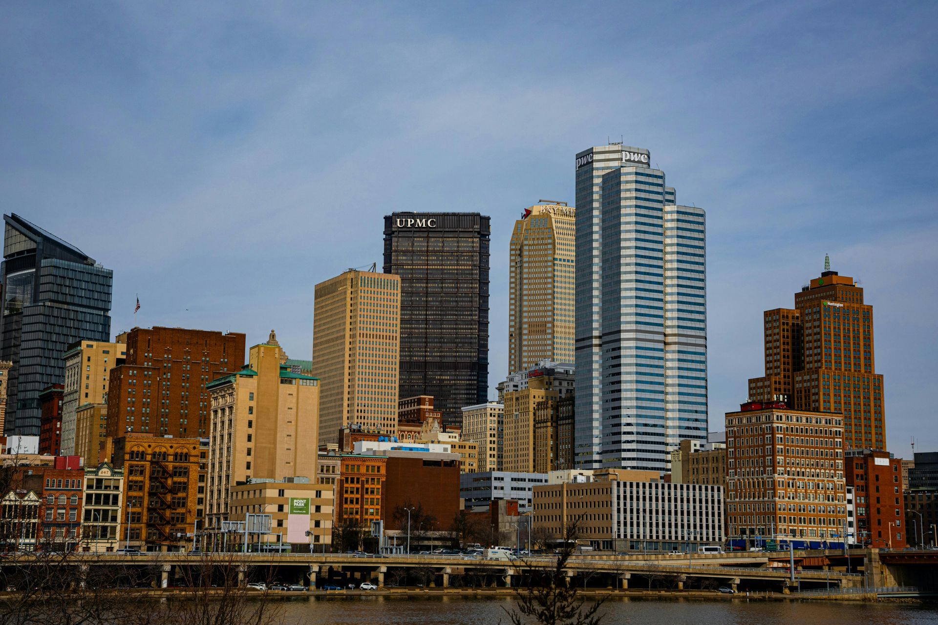 A city skyline with a yellow bridge in the foreground.