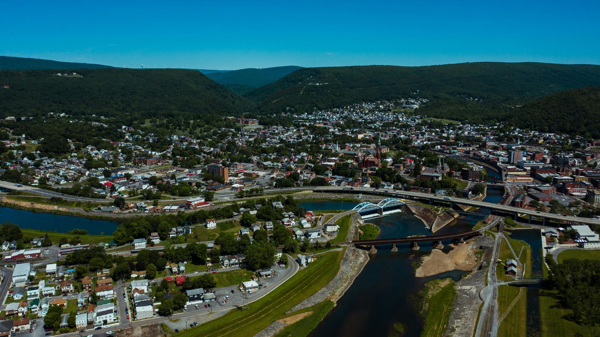 A city skyline with a yellow bridge in the foreground.