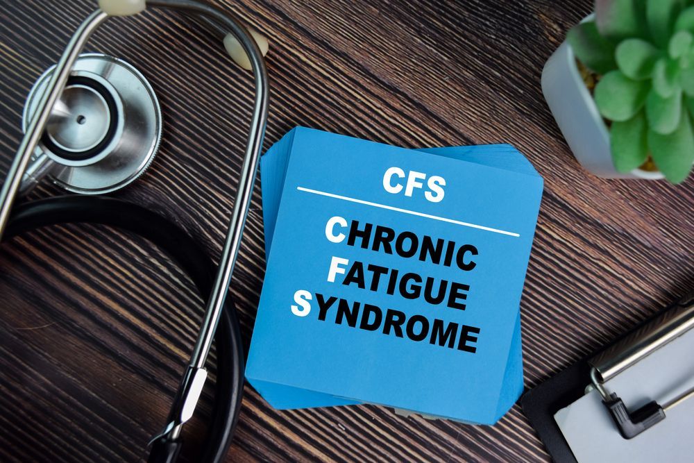 A blue piece of paper with the words cfs chronic fatigue syndrome written on it