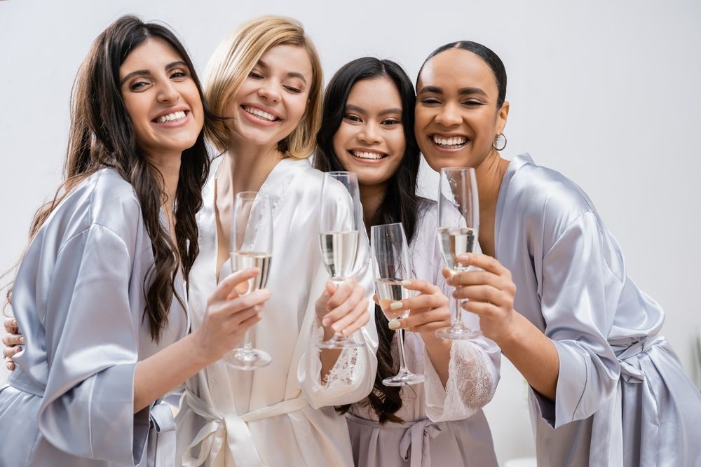 A group of women are toasting with champagne glasses.