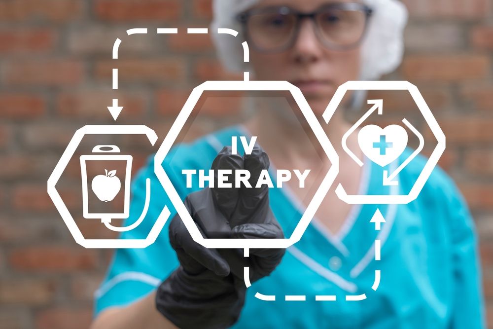 A nurse is pointing at a screen that says iv therapy