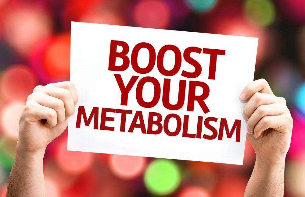 A person is holding a sign that says `` boost your metabolism ''.