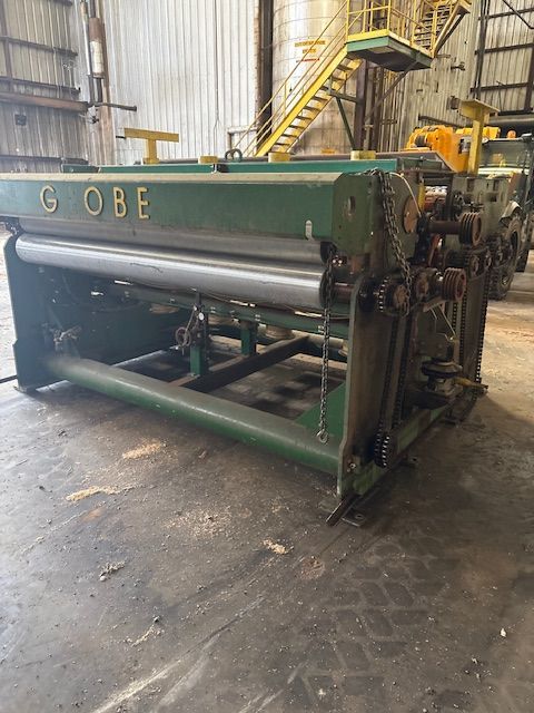 A close-up of a metal welding process, showing sparks and bright light where a rod connects to a dark metal fence frame.