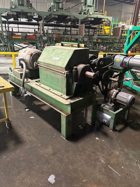 A close-up of a metal welding process, showing sparks and bright light where a rod connects to a dark metal fence frame.