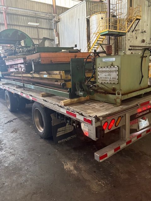 A close-up of a metal welding process, showing sparks and bright light where a rod connects to a dark metal fence frame.