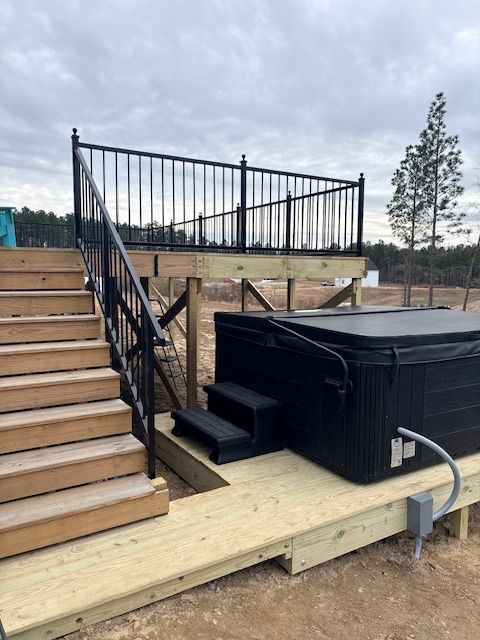 A close-up of a metal welding process, showing sparks and bright light where a rod connects to a dark metal fence frame.