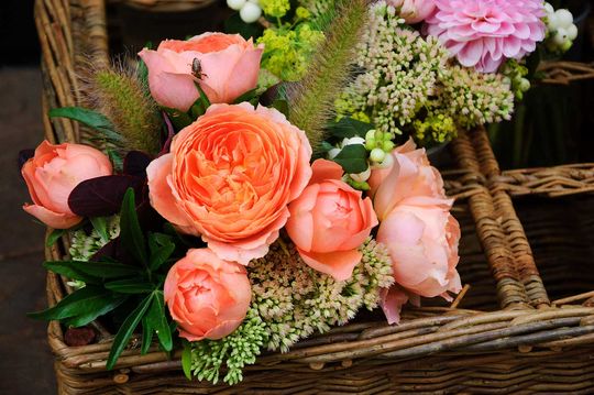 Beautiful flowers arrangement in wicker basket.
