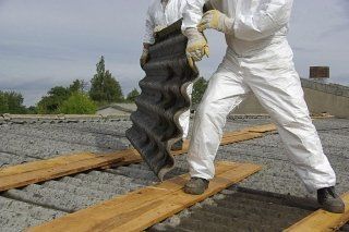 Worker removing an asbestos slab
