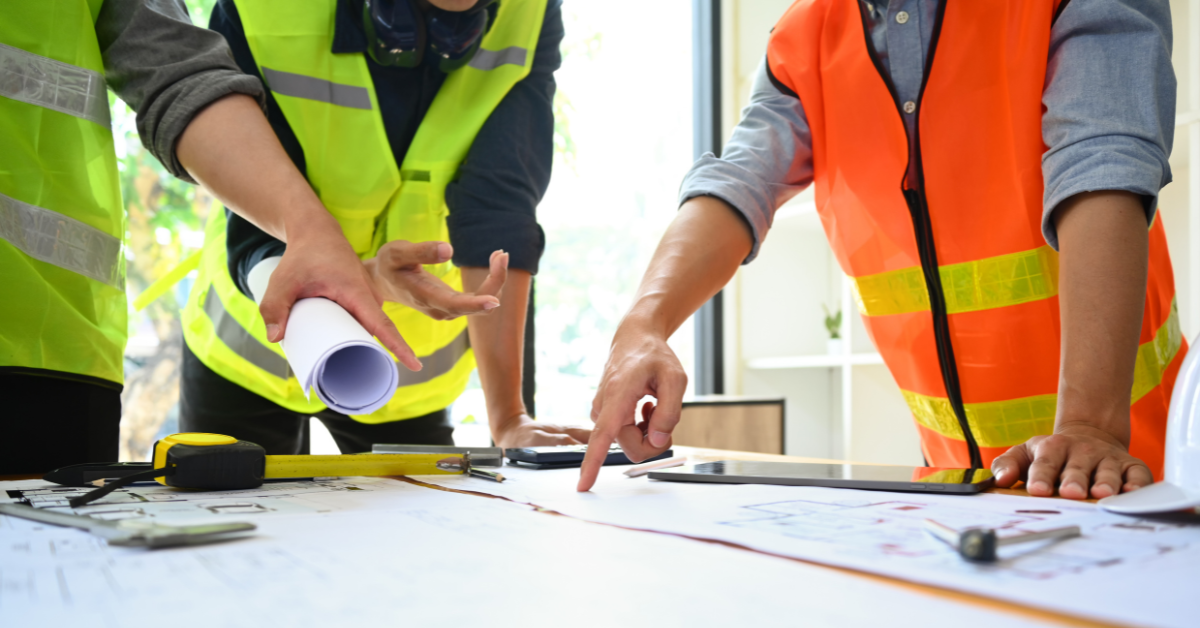 people in vests working on a project