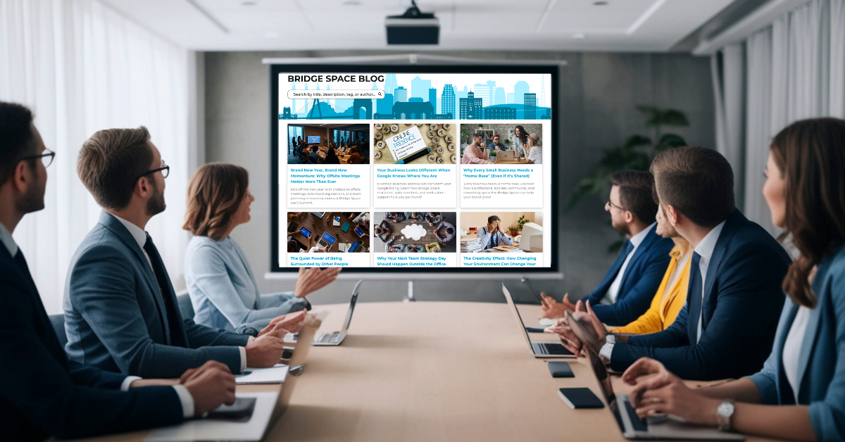 Team meeting inside a professional conference room at BridgeSpace Lee’s Summit featuring large screen display and collaborative workspace setup.