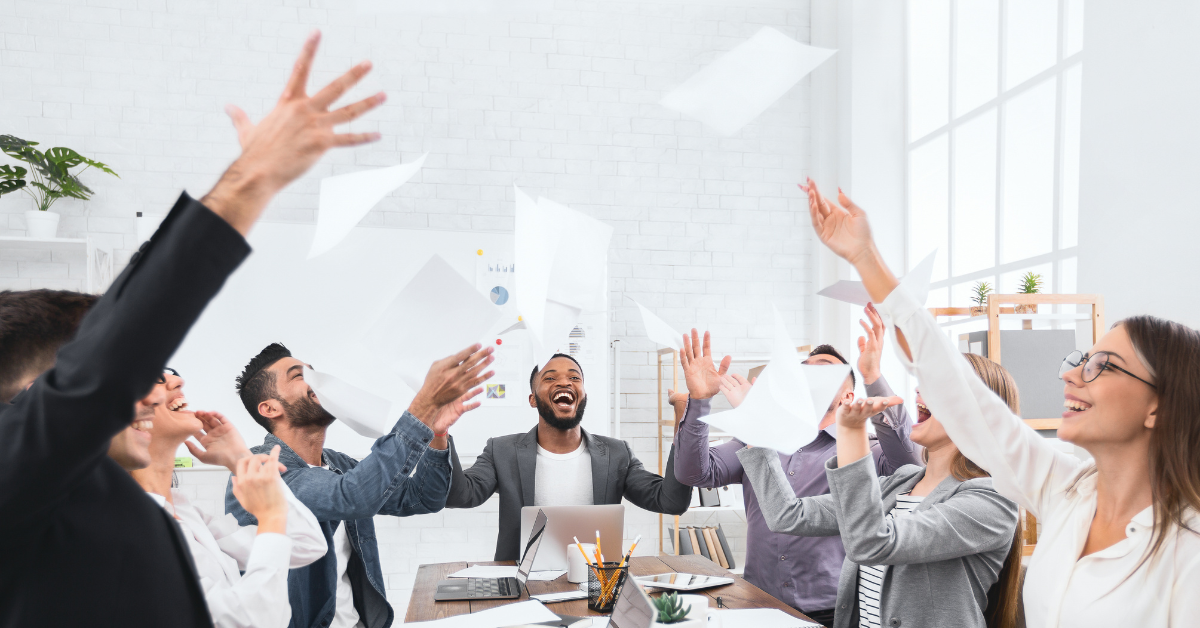 Team celebrating a successful planning session inside a conference room, representing the energy of a productive team strategy day in Lee’s Summit