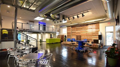 A large room with tables and chairs in it.
