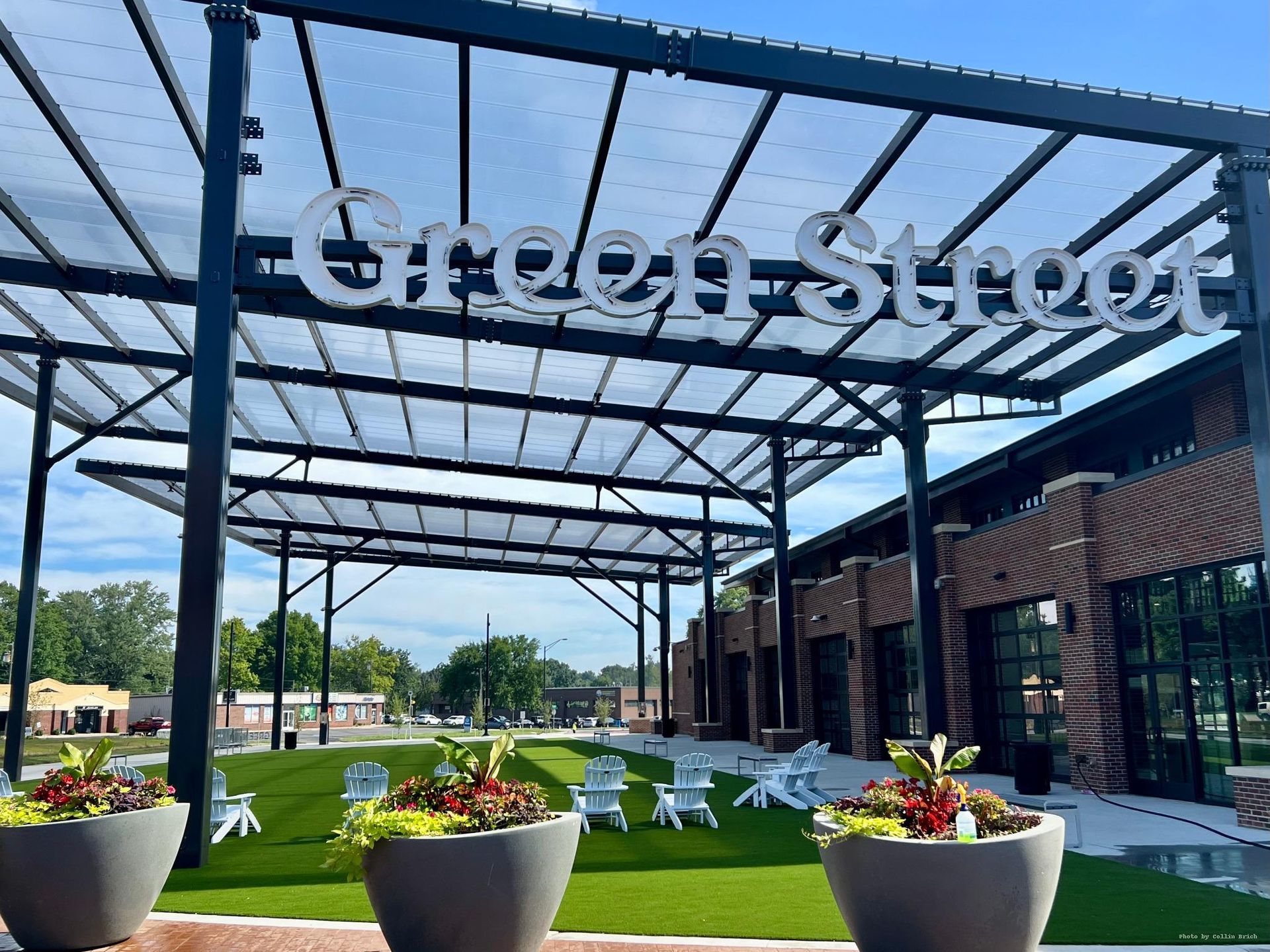 Open lawn with Adirondack chairs under pavilion at Green Street Market in Lee's Summit