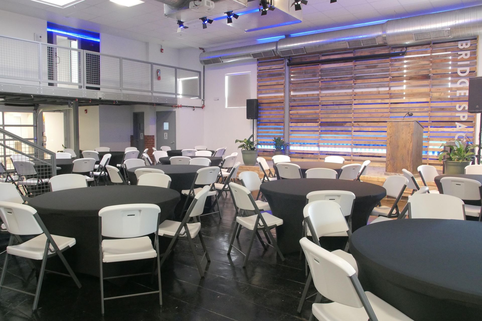A large room with tables and chairs set up for a party