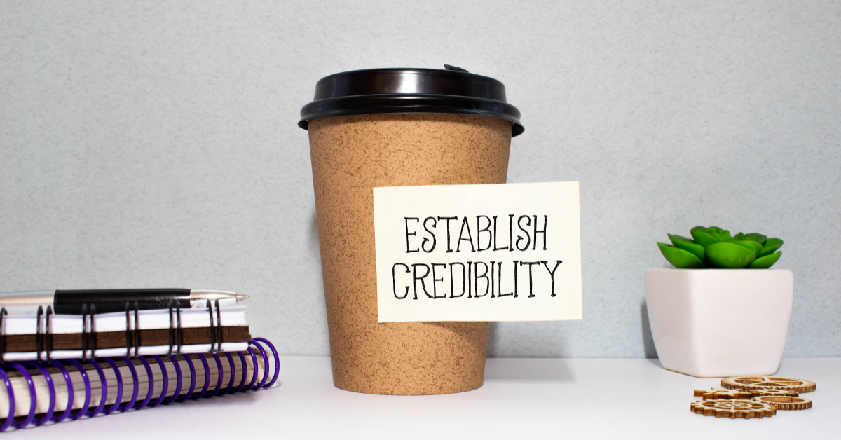 Coffee cup reading “Establish Credibility,” symbolizing professional and trust for small business owners in Lee’s Summit.