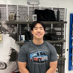 A man wearing a gray shirt with a truck on it