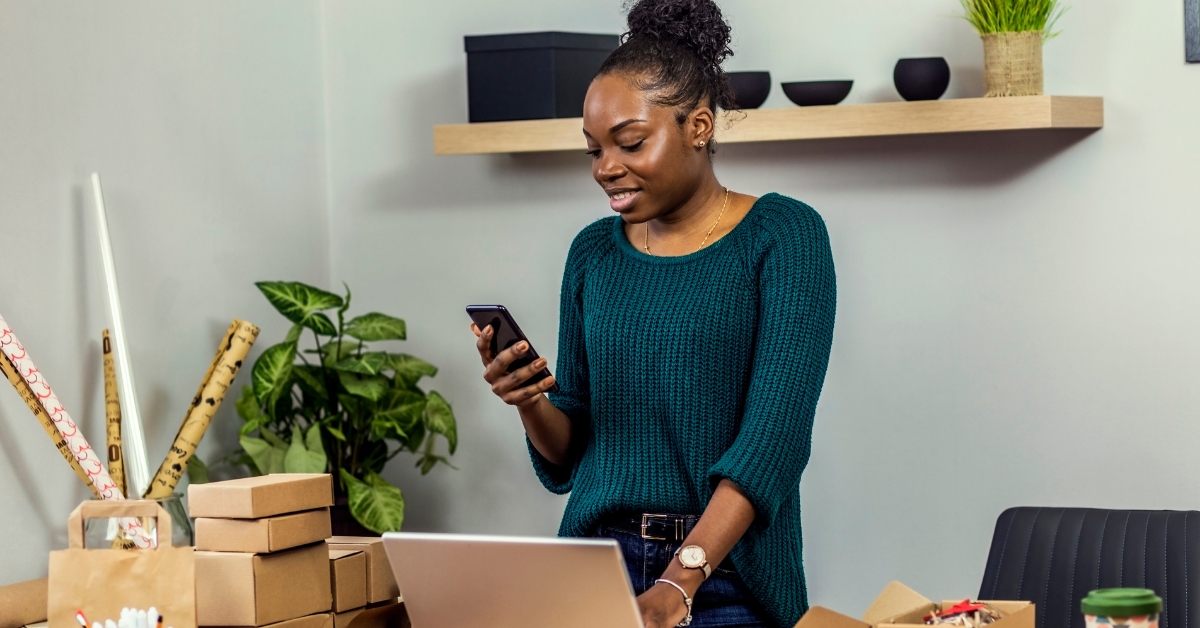 Professional working from a Bridge Space office using laptop and phone in a small business setup
