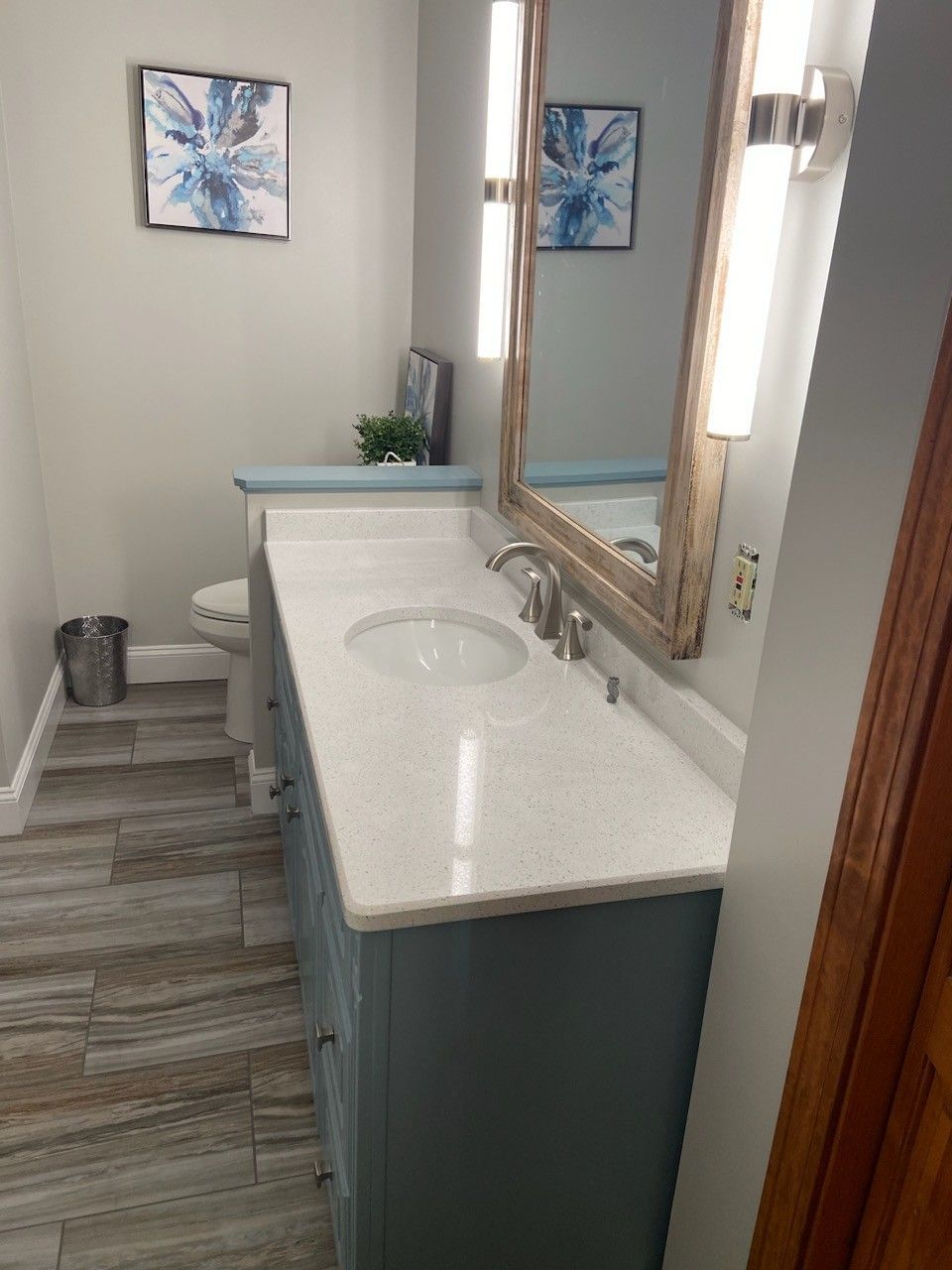 a bathroom with a toilet a sink and a mirror