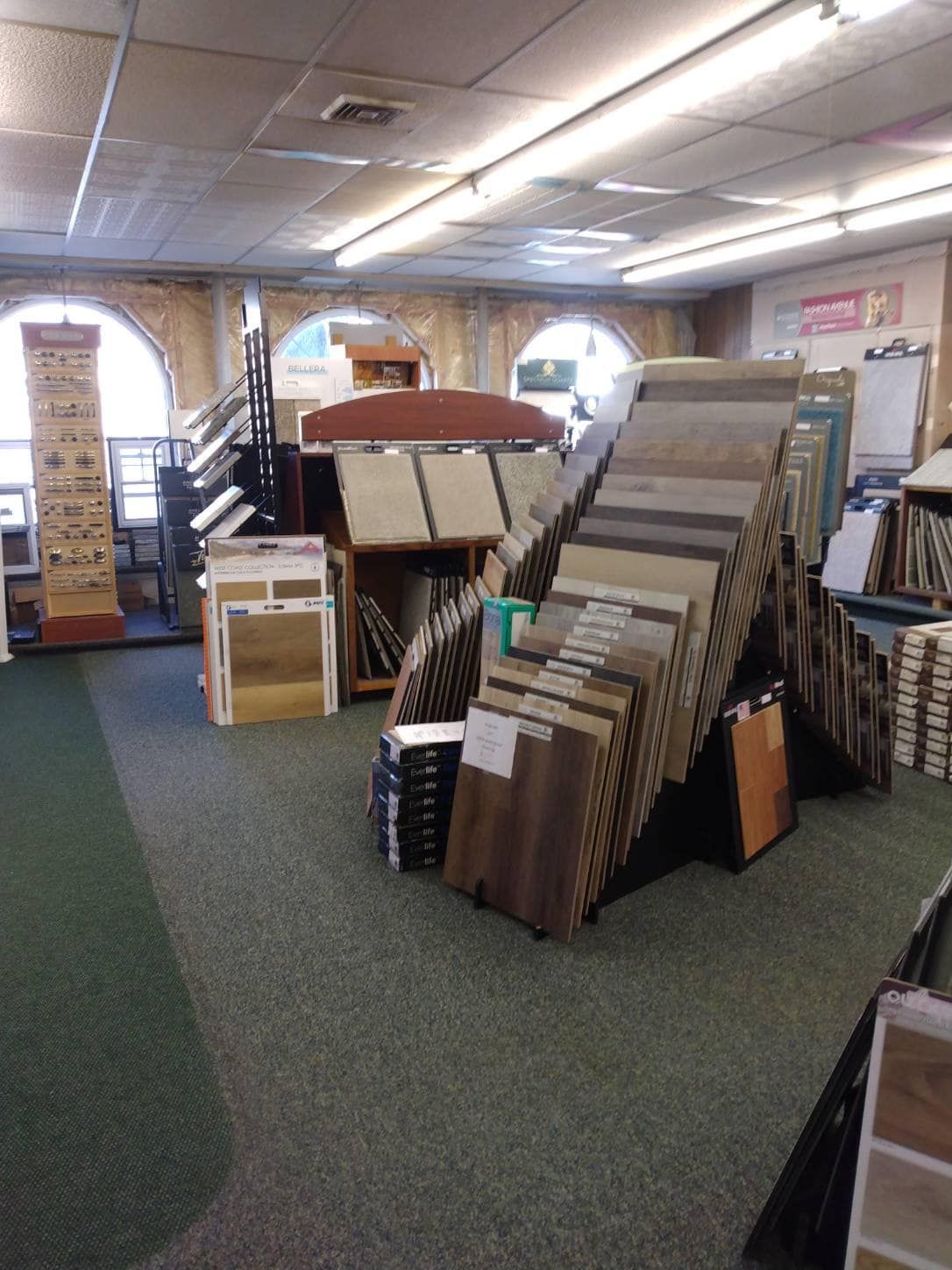 a flooring showroom with a sign that says ' marble ' on it