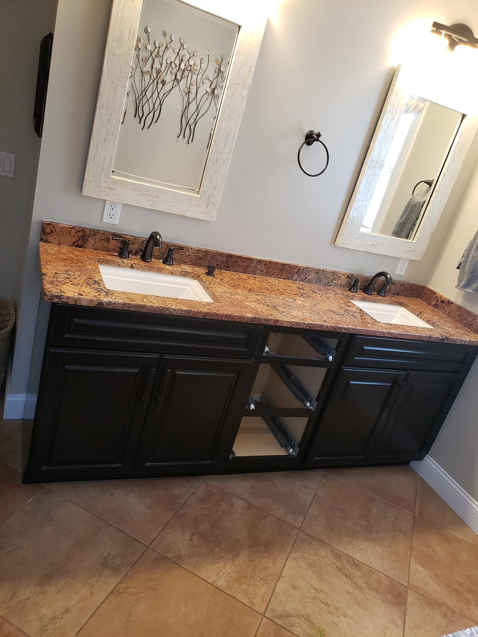 a bathroom with two sinks and two mirrors