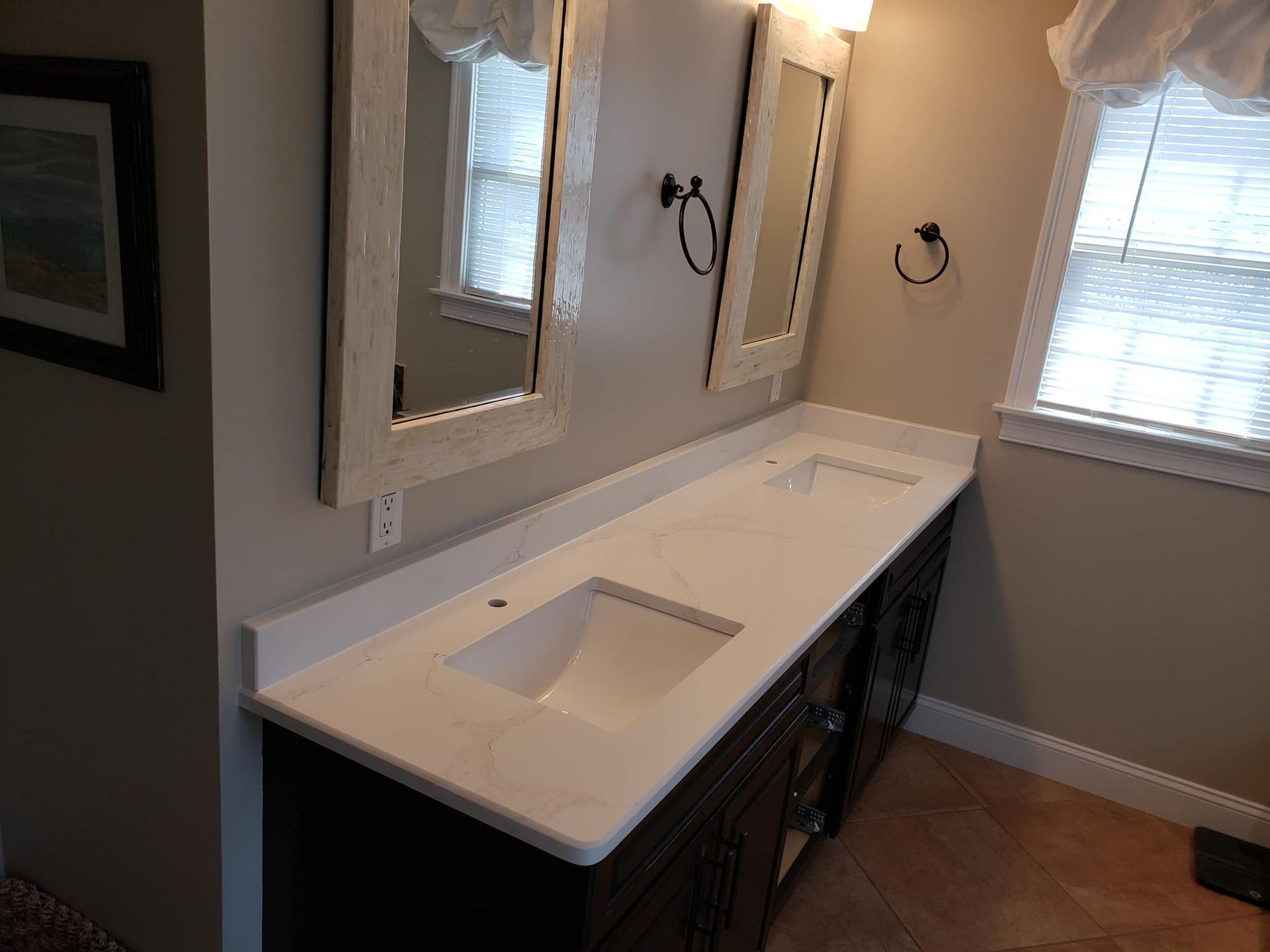 a bathroom with two sinks and two mirrors