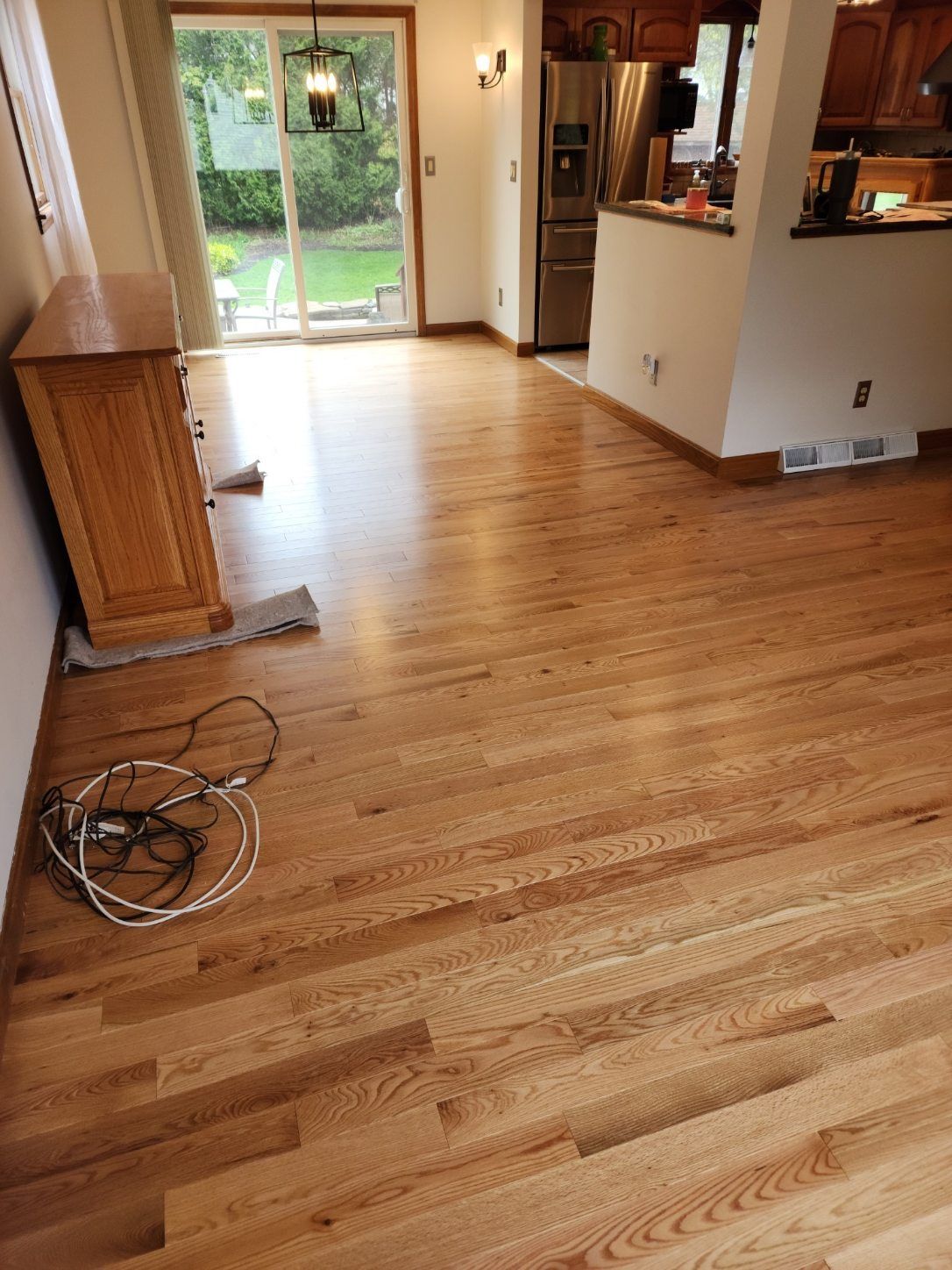 a wooden floor in a kitchen with a sliding glass door