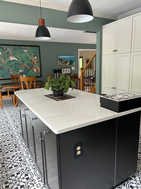 There is a large island in the middle of the kitchen.