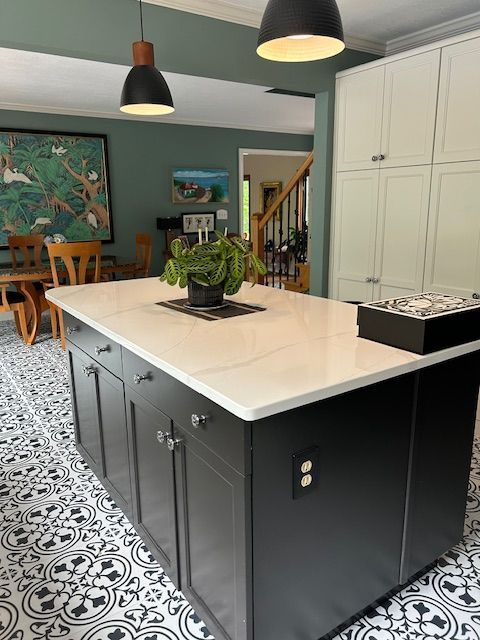 There is a large island in the middle of the kitchen.