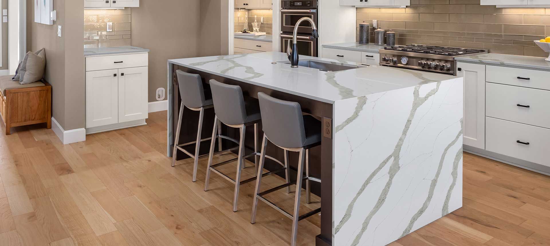 a kitchen with a large island and stools