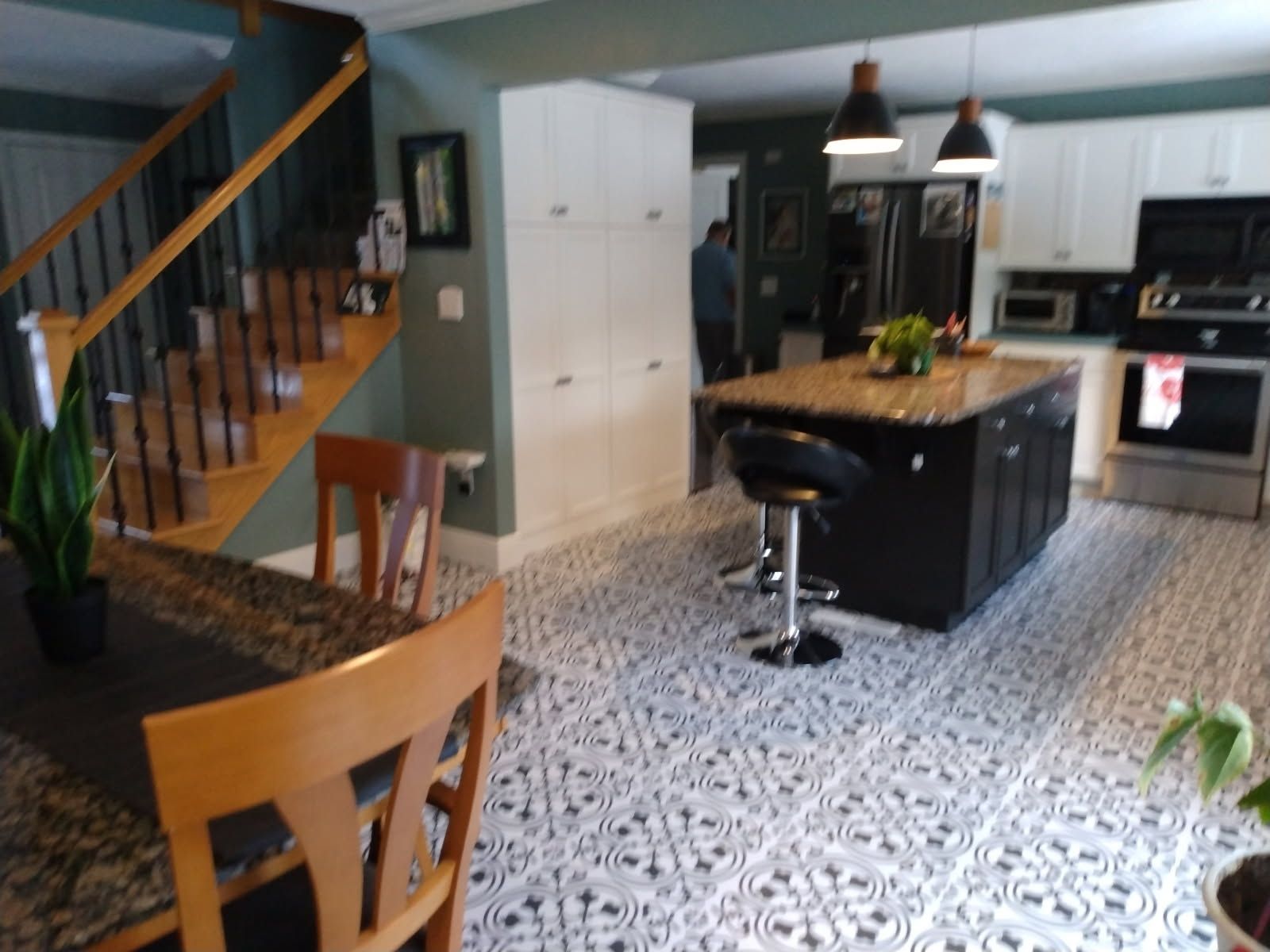A kitchen with a table and chairs and stairs