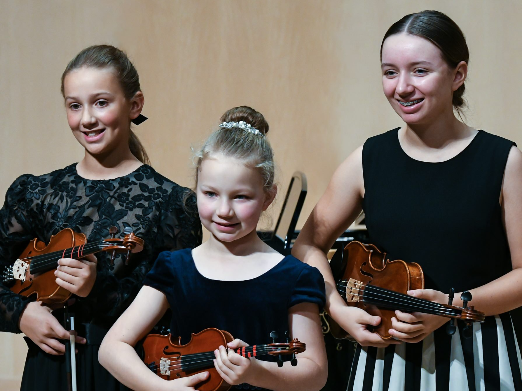 Teacher Helping Young Female Pupil In Violin Lesson
