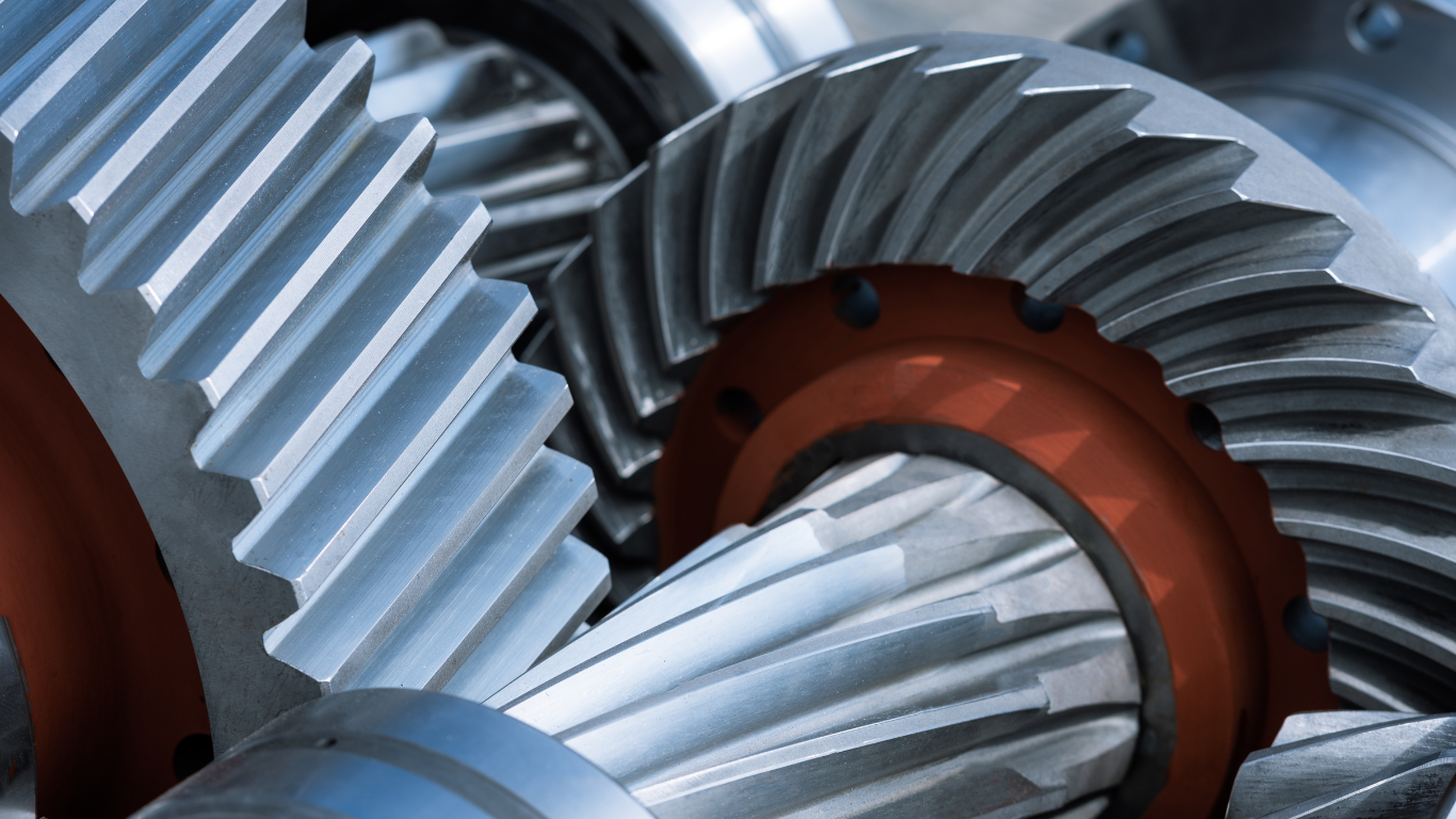 A close up of a metal gear with a red center