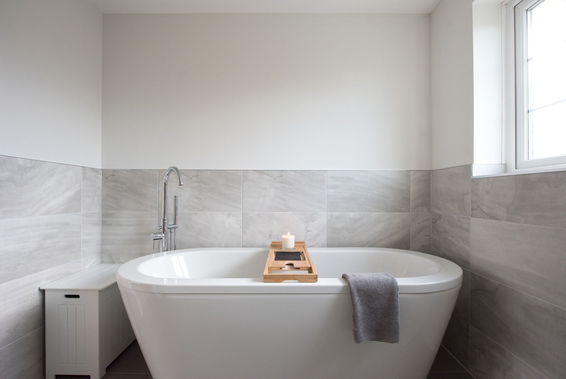 A bathroom with a bathtub and a window. A bathroom with a bathtub and a window.
