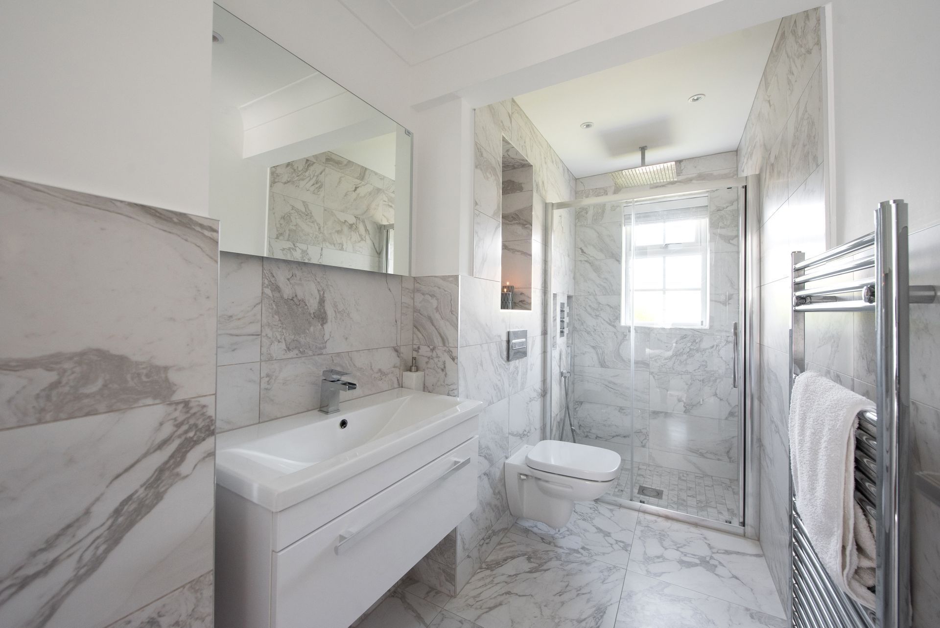 A bathroom with a sink , toilet , and walk in shower.