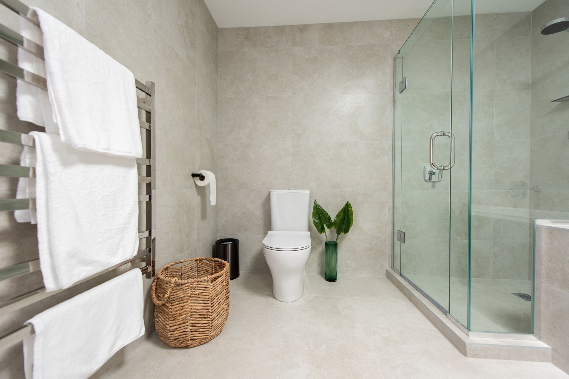 A bathroom with a toilet , shower , and towels. A bathroom with a toilet , shower , and towels.