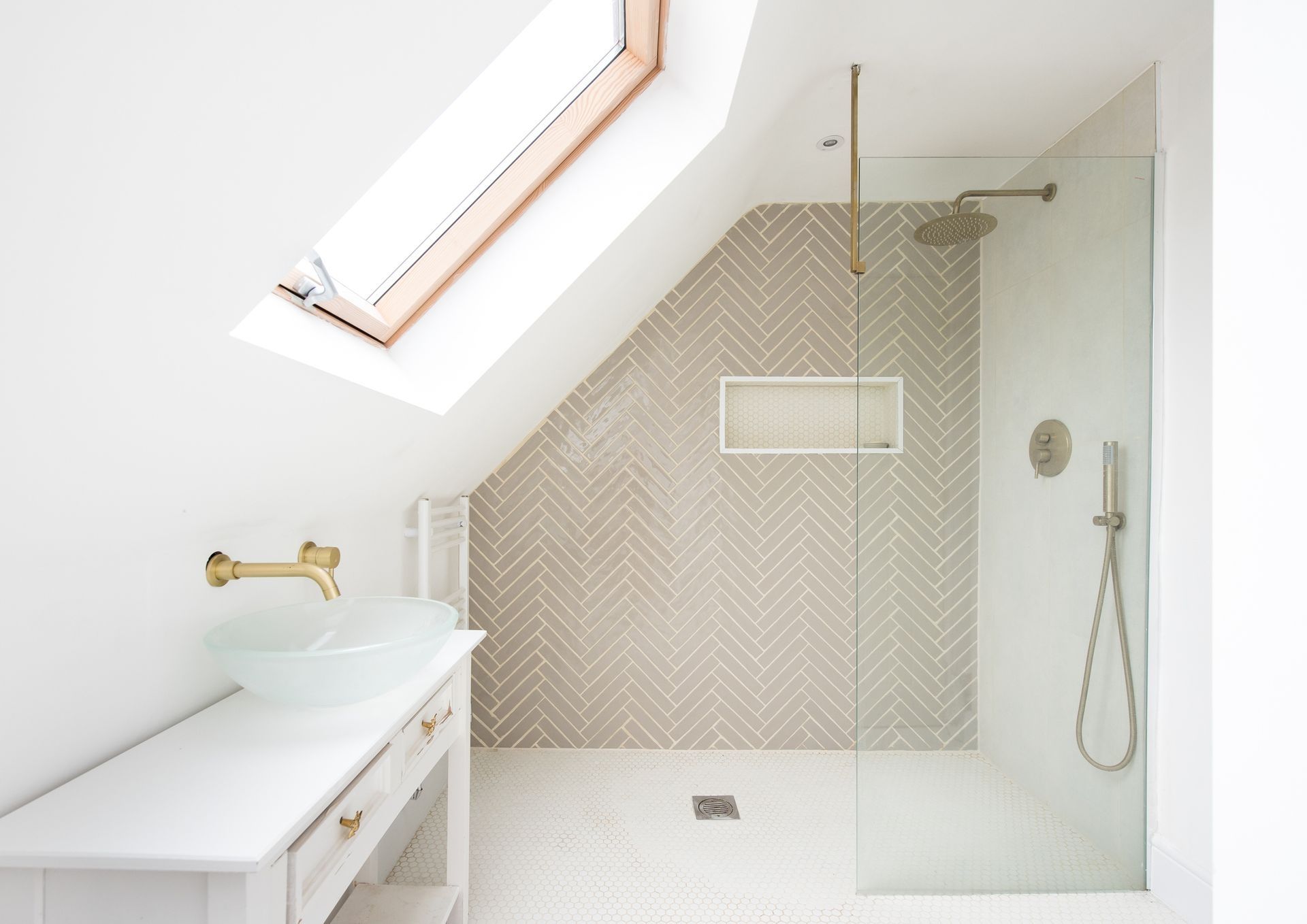A bathroom with a walk in shower and a skylight A bathroom with a walk in shower and a skylight