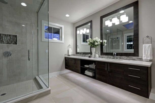 Bathroom with a walk-in shower and double sinks, designed by bathroom remodelers at Midwest Bath Co. in Machesney Park, IL.