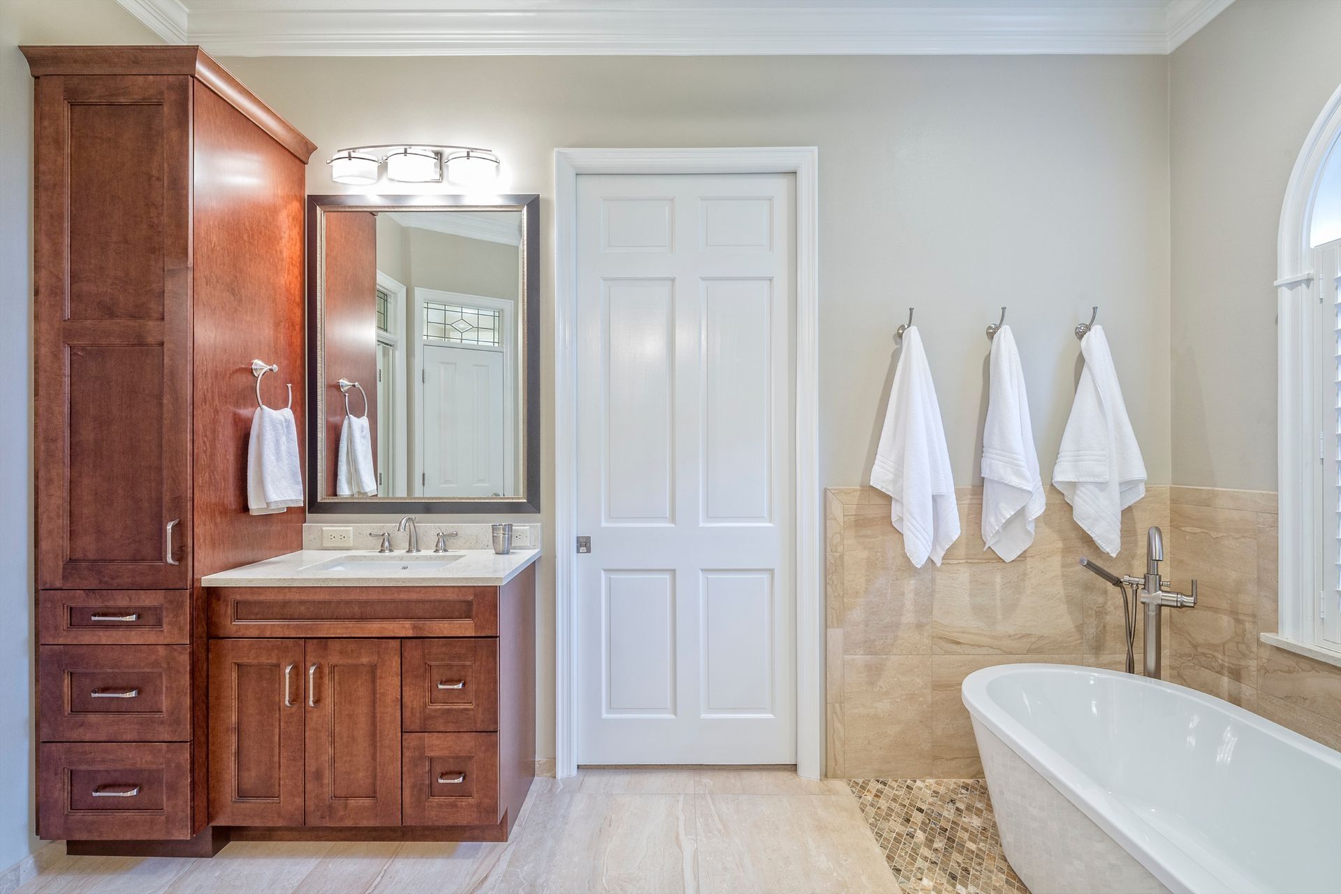A bathroom with a tub, sink and mirror. A bathroom with a tub, sink and mirror.