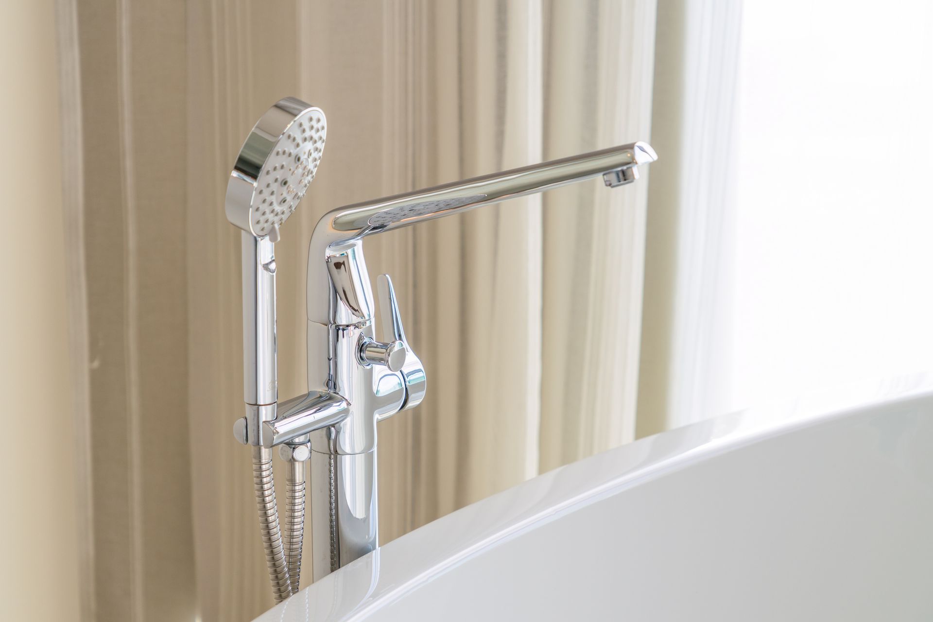 Luxury bathtub with curtain background and lighting from the door.