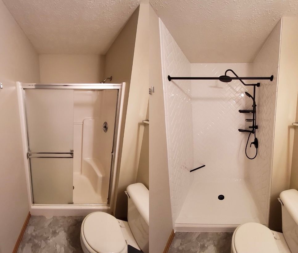 A bathroom with a toilet and a shower stall
